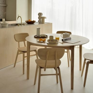a modern round oak extending dining table saving space and sits into any shape room 