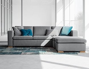 Grey Corner Sofa Bed Designed By Adventures In Furniture. This Modern Sofa Bed Has Endless Fabric Choices To Fit Every Space In Your Home. The cream sofa on display looks complete with a turquoise cushions