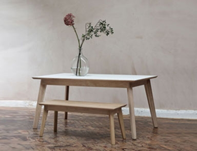 White Fenix dining table with matching bench By Adventures In Furniture.