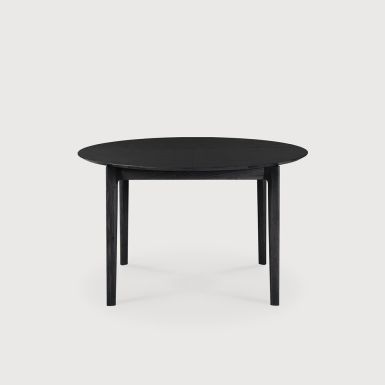 a modern round oak extending dining table saving space and sits into any shape room 