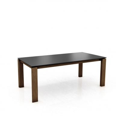 A solid oak extending dining table with straight legs dark brown
